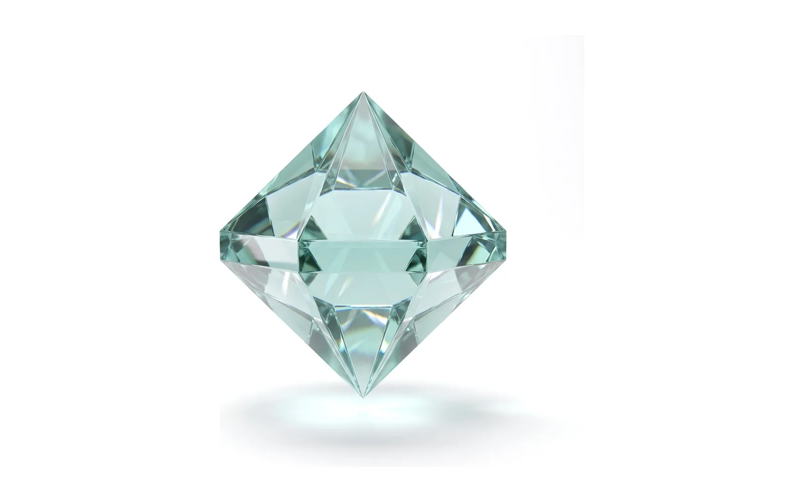 A faceted crystal cut as an octahedron in pale teal glass